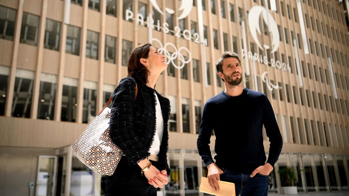 French President of the Paris Organising Committee of the 2024 Olympic and Paralympic Games Tony Estanguet (R) speaks with French Sports, Olympic and Paralympic Games Minister Amelie Oudea-Castera during a visit to the headquarters of Paris 2024.