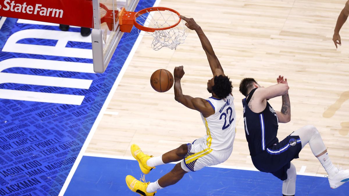 Andrew Wiggins #22 of the Golden State Warriors dunks the ball against Luka Doncic #77 of the Dallas Mavericks during the fourth quarter in Game Three of the 2022 NBA Playoffs Western Conference Finals at American Airlines Center on May 22, 2022 in Dallas