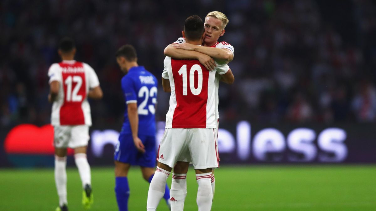 Donny van de Beek of Ajax celebrates scoring his teams first goal of the game with team mate Dusan Tadic during the UEFA Champions League Play-off 1st leg match between Ajax and Dynamo Kiev