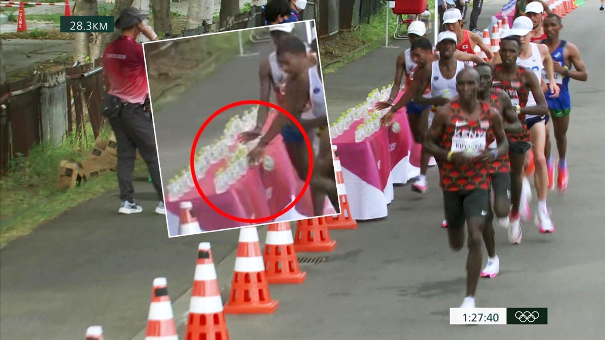 Shocking moment marathon runner Morhad Amdouni knocks drinks off table, takes one