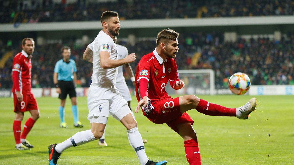 Moldova's Catalin Carp in action with France's Olivier Giroud