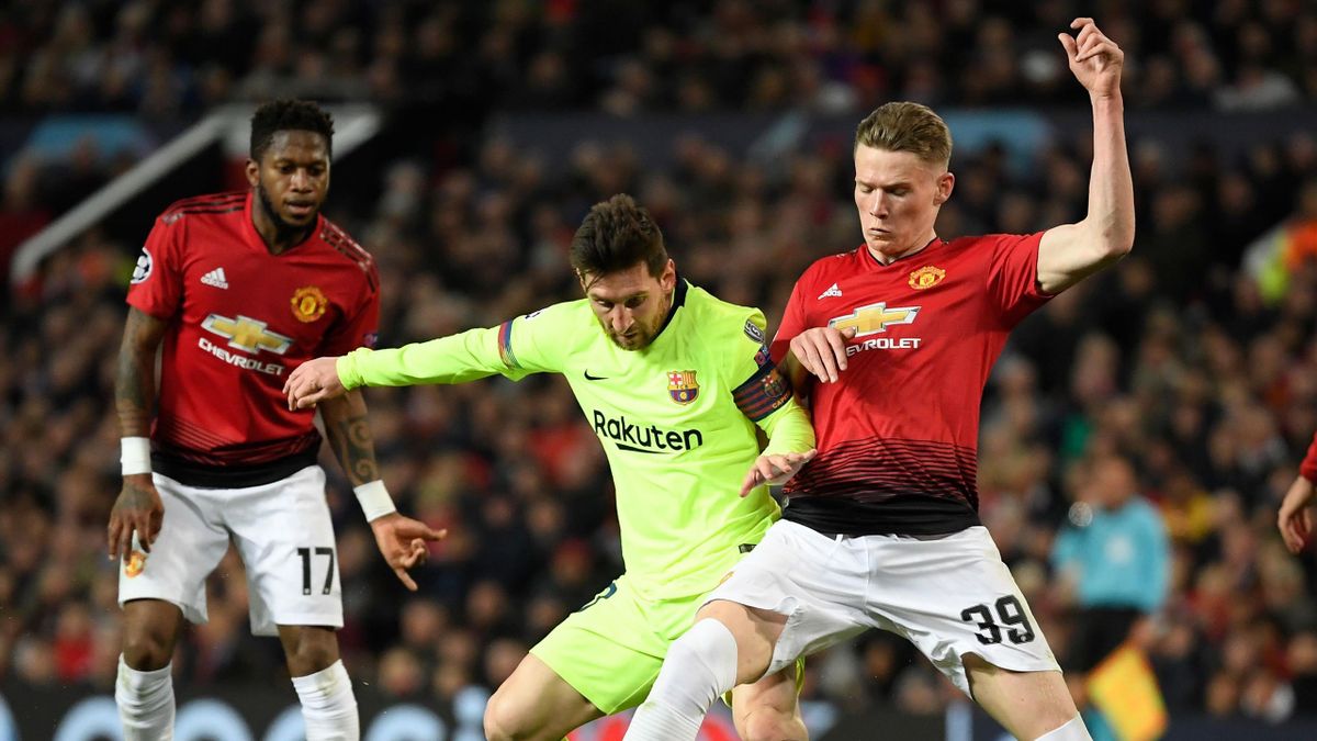 Lionel Messi of Barcelona is challenged by Scott McTominay of Manchester United