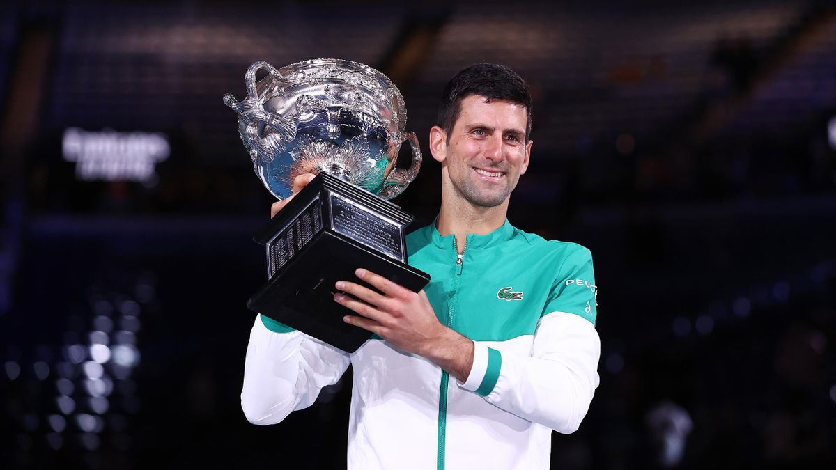 Novak Djokovic of Serbia holds the Norman Brookes Challenge Cup as he celebrates victory in his Men’s Singles Final match against Daniil Medvedev of Russia during day 14 of the 2021 Australian Open at Melbourne Park