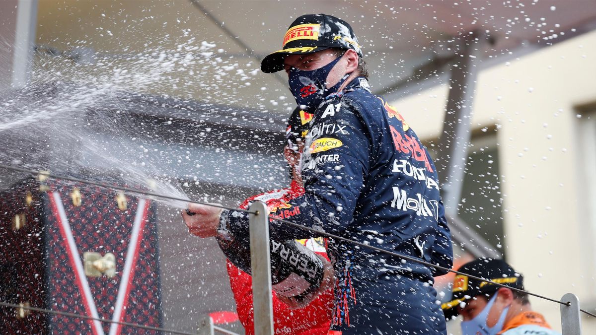 Winner Red Bull's Dutch driver Max Verstappen (C) celebrates with sparkling wine during the podium ceremony after the Monaco Formula 1 Grand Prix at the Monaco street circuit in Monaco, on May 23, 2021. (Photo by Sebastien Nogier / AFP) (P