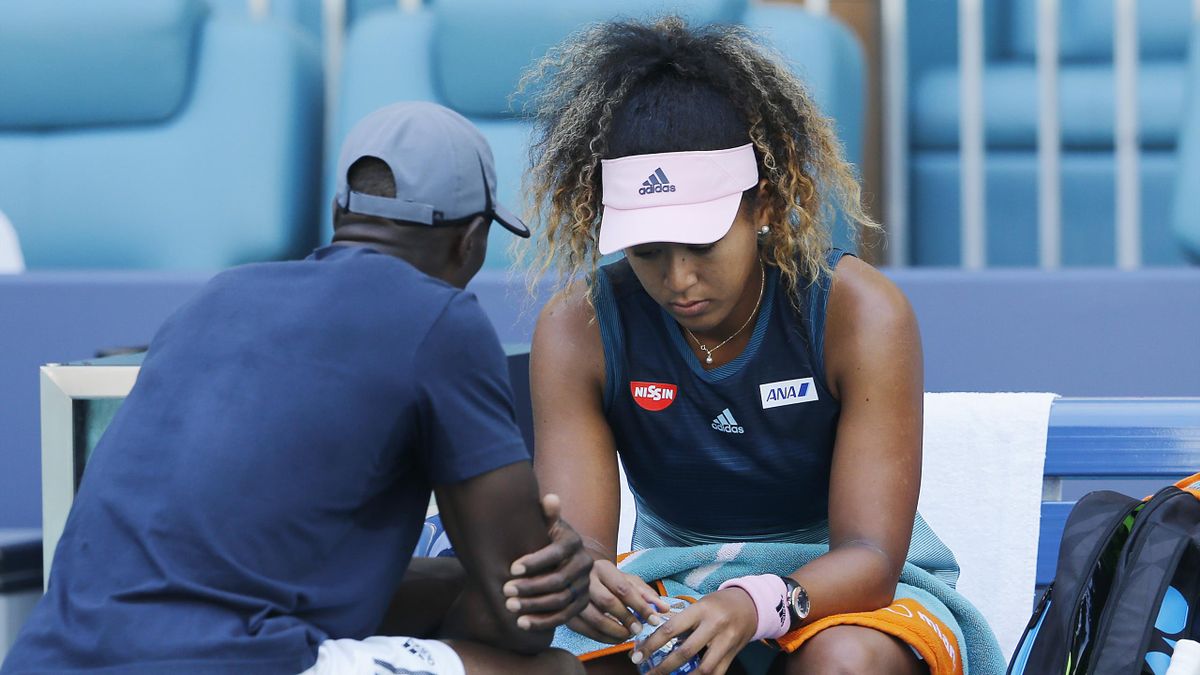 Naomi Osaka of Japan talks to her coach, Jermaine Jenkins, during a changeover against Yanina Wickmayer of Belgium during Day 5 of the Miami Open Presented by Itau at Hard Rock Stadium on March 22, 2019 in Miami Gardens, Florida.