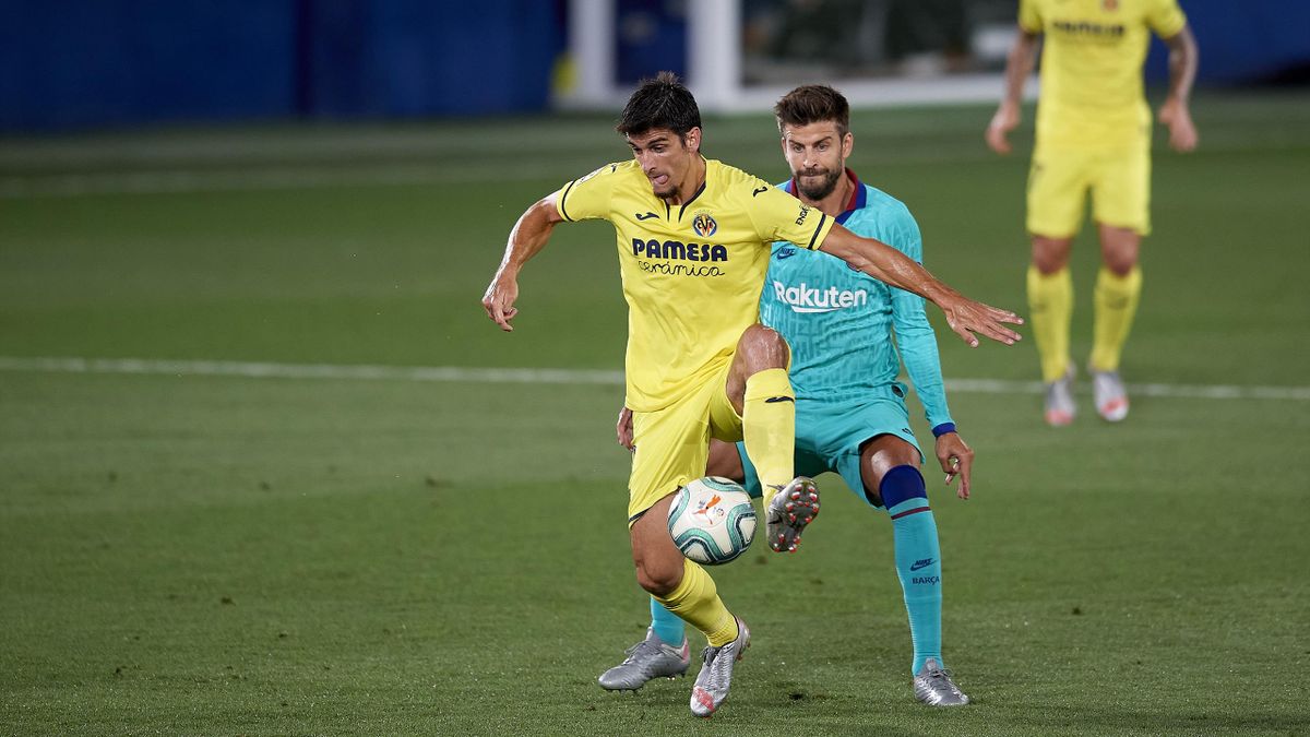 Gerard Moreno of Villarreal and Gerard Pique of Barcelona compete for the ball during the Liga match between Villarreal CF and FC Barcelona at Estadio de la Ceramica on July 5, 2020