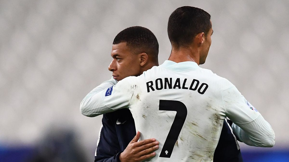 Portugal's forward Cristiano Ronaldo (R) embraces France's forward Kylian Mbappe at the end of the Nations League football match between France and Portugal, on October 11, 2020 at the Stade de France in Saint-Denis, outside Paris