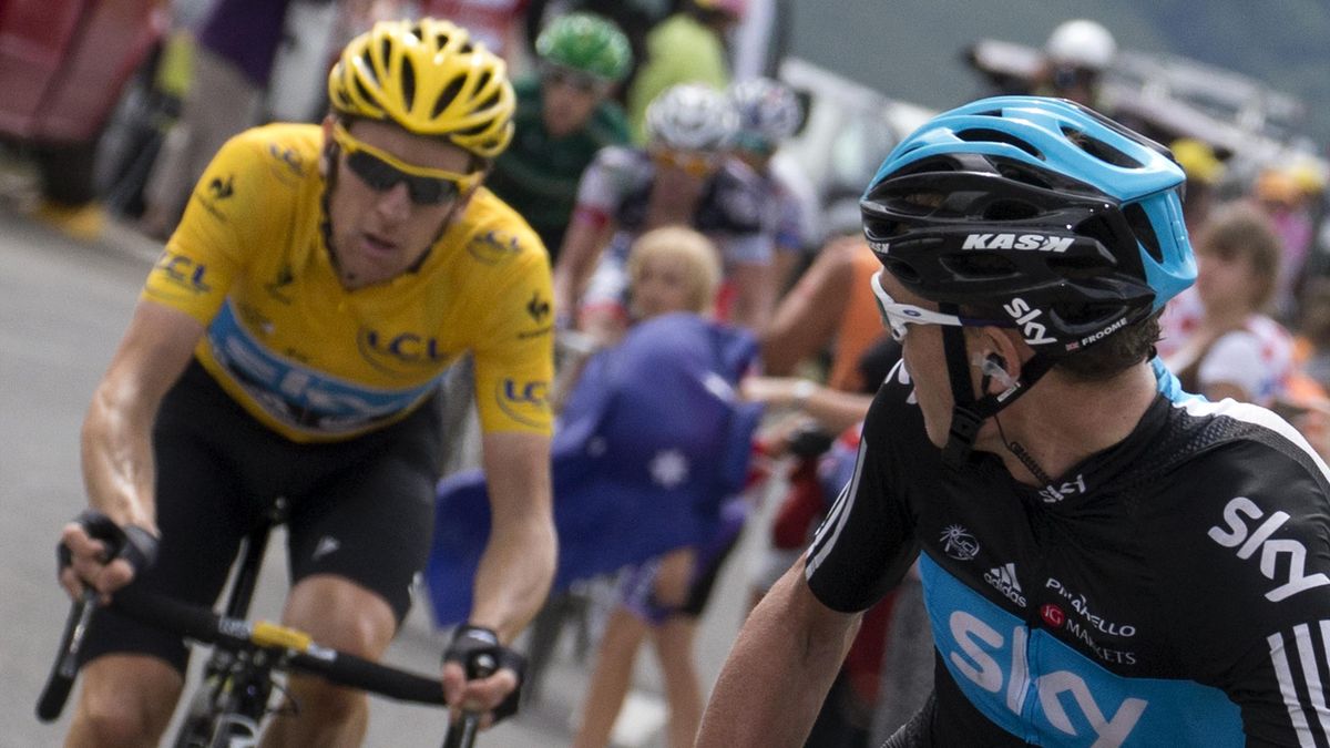 Second placed in the overall standings, Great Britain's Christopher Froome (R) looks at overall leader's yellow jersey, British Bradley Wiggins (L) as they ride in the 143,5 km and seventeenth stage of the 2012 Tour de France