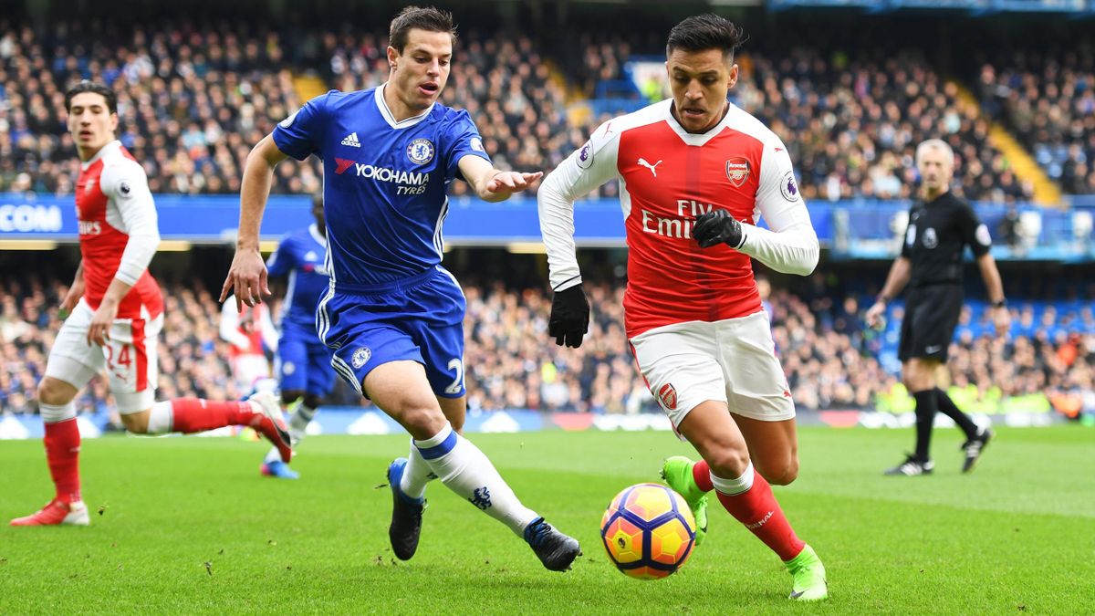 Alexis Sanchez of Arsenal runs with the ball under pressure from Cesar Azpilicueta of Chelsea