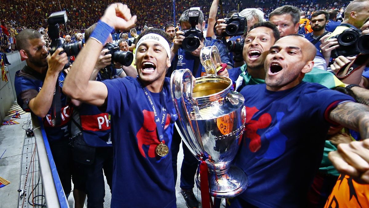 Barcelona's Neymar, Adriano and Dani Alves celebrate with the trophy after winning the UEFA Champions League Final