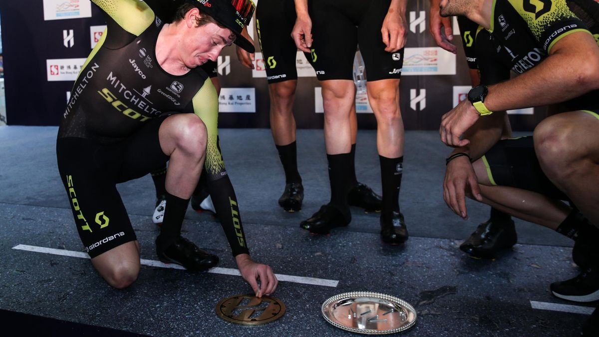 Professional cyclists of Team Mitchelton-Scott attend the award ceremony