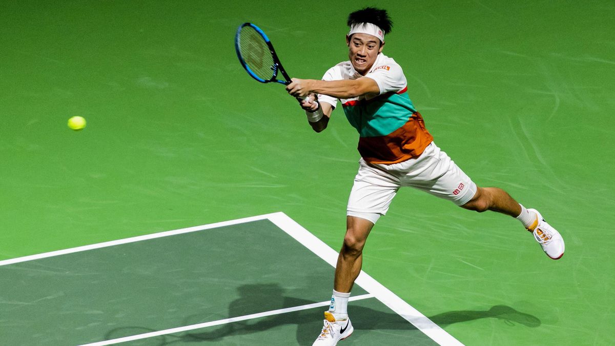 Kei Nishikori plays a backhand return to France's Pierre-Hugues Herbert during their men's singles match on day two of the ABN AMRO World Tennis Tournament in Rotterdam on February 12, 2019.