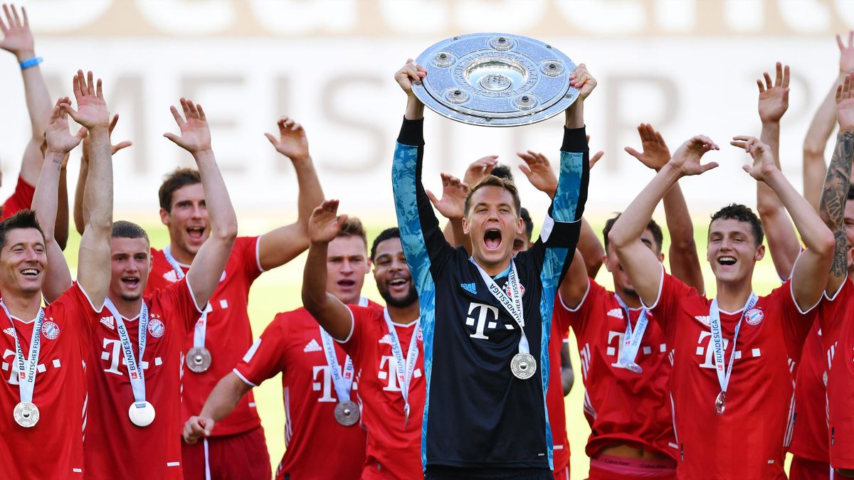 Team captain Manuel Neuer of FC Bayern Muenchen lifts the trophy to celebrate the championship following the Bundesliga match between VfL Wolfsburg and FC Bayern Muenchen at Volkswagen Arena on June 27, 2020 in Wolfsburg, Germany.