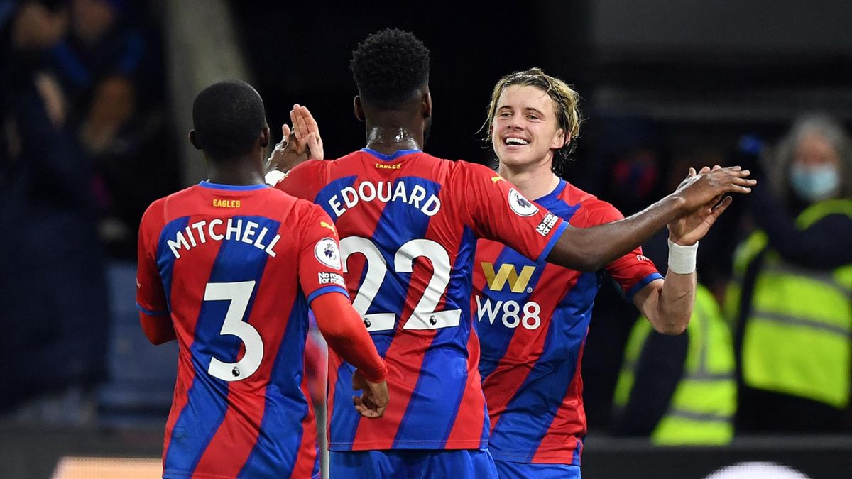 Crystal Palace's English midfielder Conor Gallagher (R) celebrates scoring his team's first goal with Crystal Palace's English defender Tyrick Mitchell (L) and Crystal Palace's French striker Odsonne Edouard during the English Premier League football game