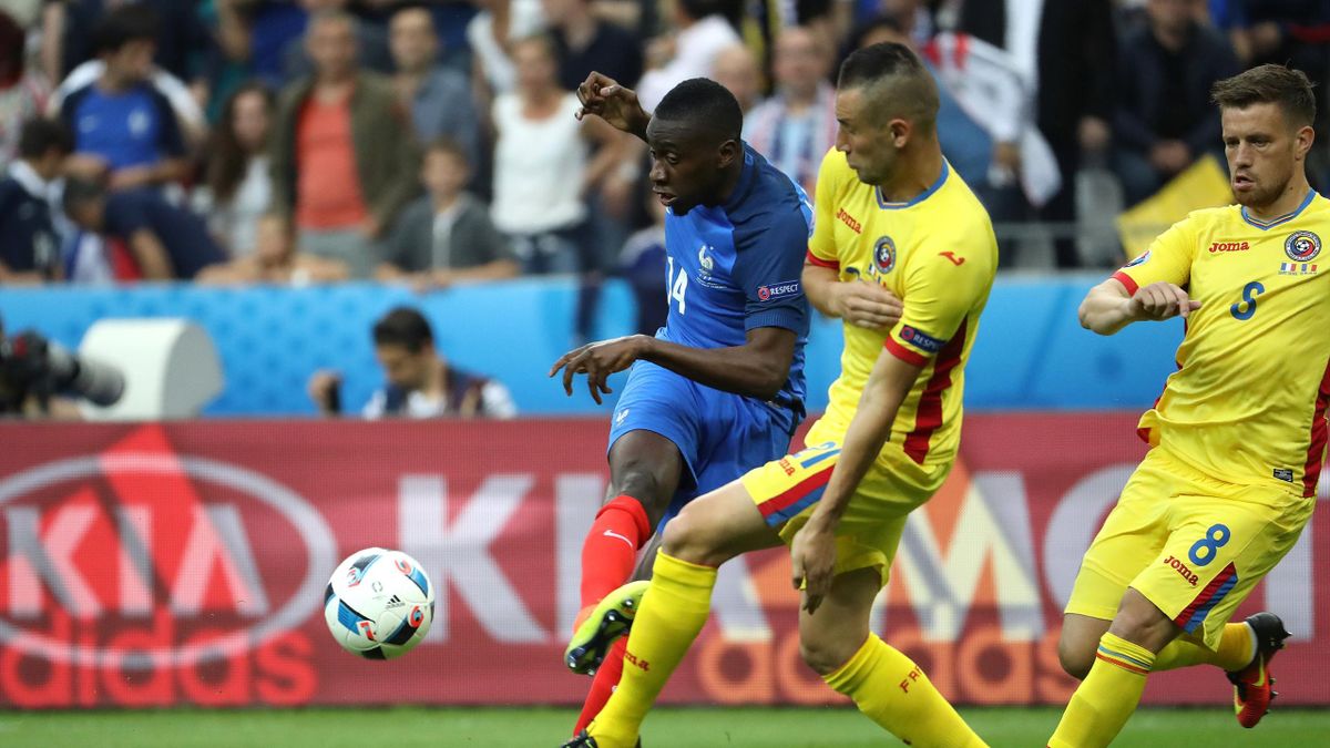 France's midfielder Blaise Matuidi (L) vies for the ball with Romania's defender Dragos Grigore