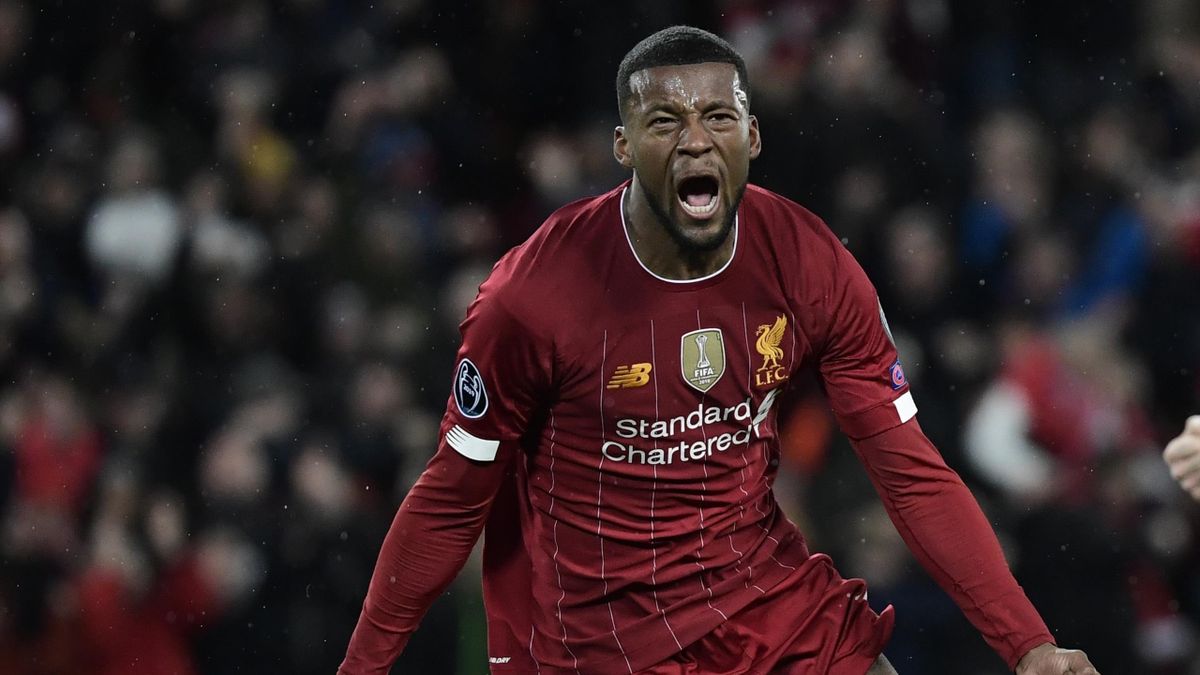 Liverpool's Dutch midfielder Georginio Wijnaldum celebrates after he scores his team's first goal during the UEFA Champions league Round of 16 second leg football match between Liverpool and Atletico Madrid at Anfield in Liverpool, north west England on M