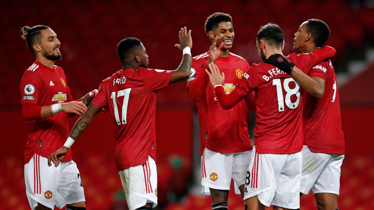 Bruno Fernandes of Manchester United celebrates with team mates (l - r) Alex Telles, Fred, Marcus Rashford and Anthony Martial after scoring their sides sixth goal during the Premier League match between Manchester United and Leeds United at Old Trafford