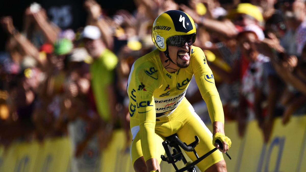 France's Julian Alaphilippe, wearing the overall leader's yellow jersey celebrates as he crosses the finish line of the thirteenth stage of the 106th edition of the Tour de France cycling race, a 27,2-kilometer individual time-trial in Pau, on July 19, 20