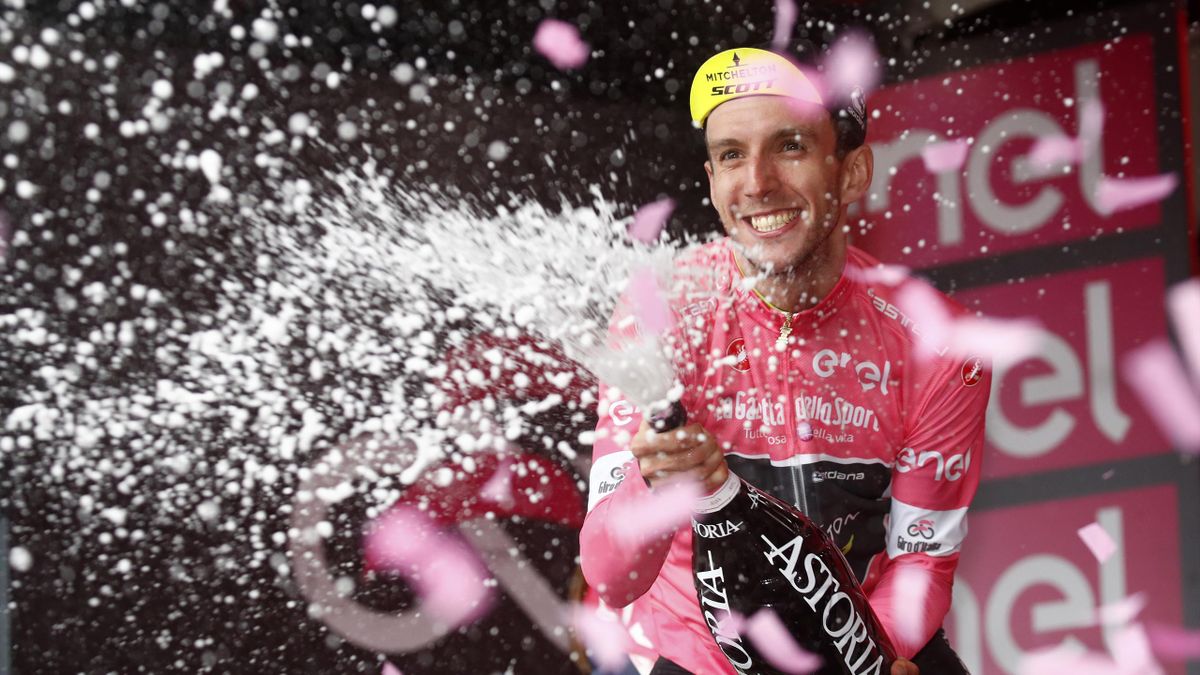 Simon Yates celebrates taking the pink jersey