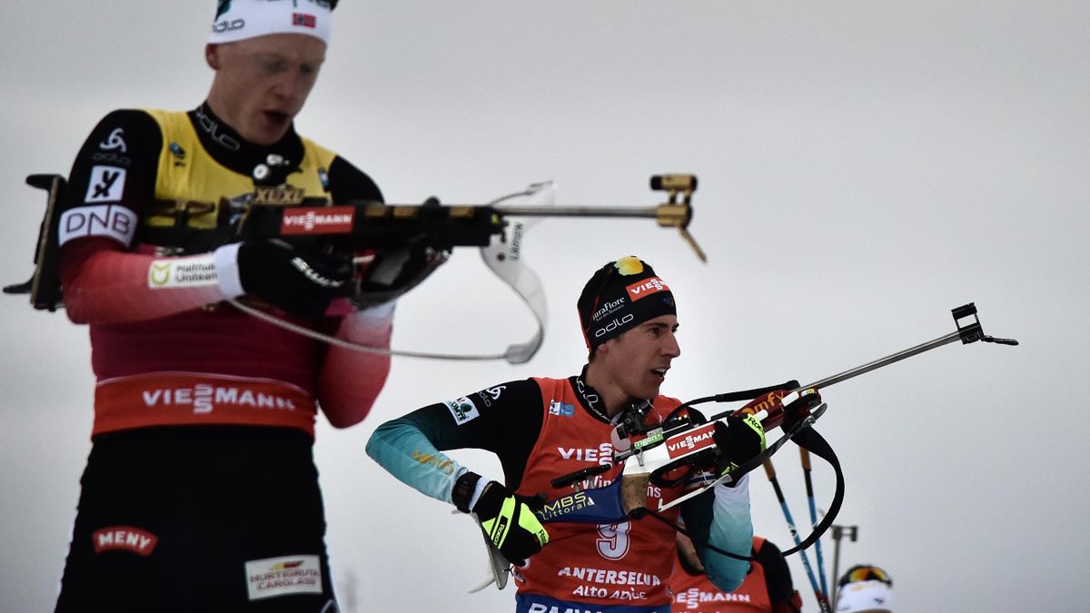 Norway's Johannes Thingnes Boe (L) and France's Quentin Fillon Maillet (2ndL) compete at the shooting range during the men's 15 km mass start event of the IBU Biathlon World Cup in Rasen-Antholz (Rasun Anterselva), Italian Alps, on January 27, 2019. (Phot