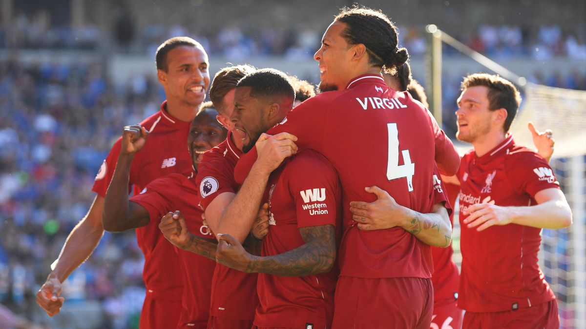 Georginio Wijnaldum of Liverpool (C) celebrates as he scores his team's first goal with Virgil van Dijk (4) and team mates during the Premier League match between Cardiff City and Liverpool FC at Cardiff City Stadium on April 21, 2019 in Cardiff, United K