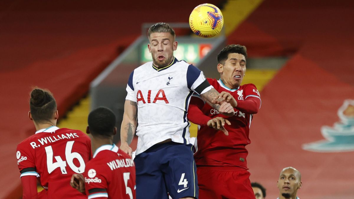 Tottenham Hotspur's Belgian defender Toby Alderweireld (C) jumps to header the ball with Liverpool's Brazilian midfielder Roberto Firmino (2R) during the English Premier League football match between Liverpool and Tottenham Hotspur at Anfield in Liverpool