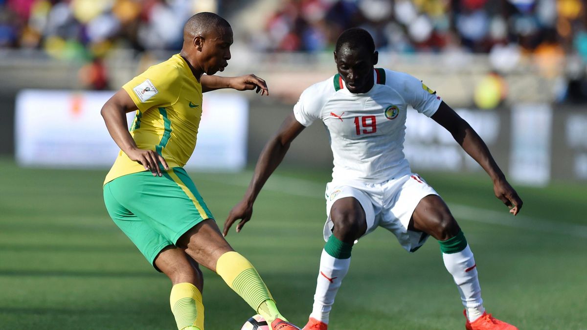 South Africa's Andile Jali (L) passes Senegal's Saliou Ciss (R) during the 2018 World Cup qualifying football match between South Africa and Senegal on November 12, 2016