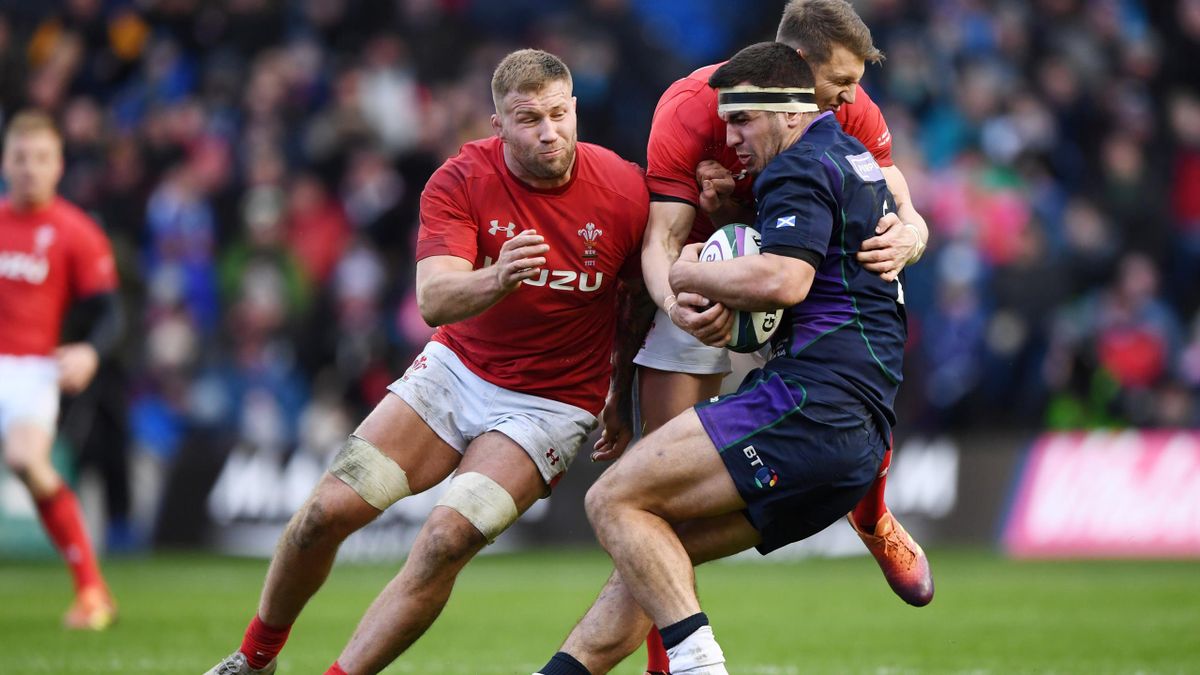 Stuart McInally of Scotland is tackled by Dan Biggar of Wales during the Guinness Six Nations