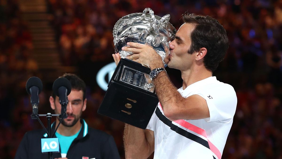 Roger Federer of Switzerland kisses the Norman Brookes Challenge Cup