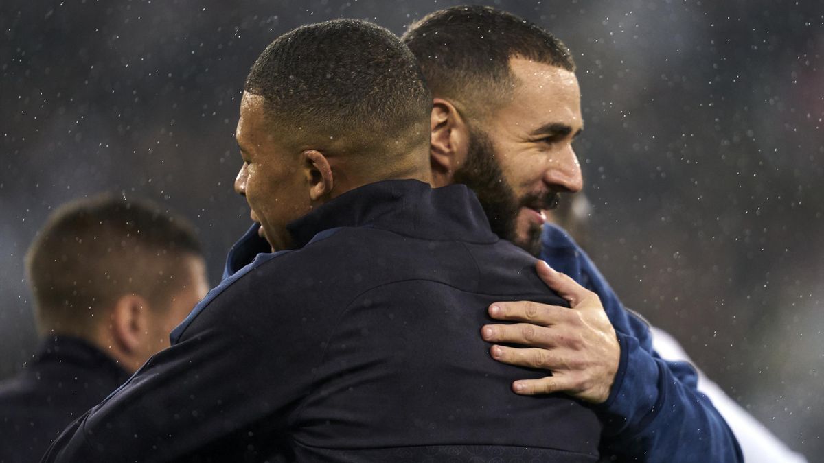 Kylian Mbappe and Karim Benzema embrace after meeting with their clubs