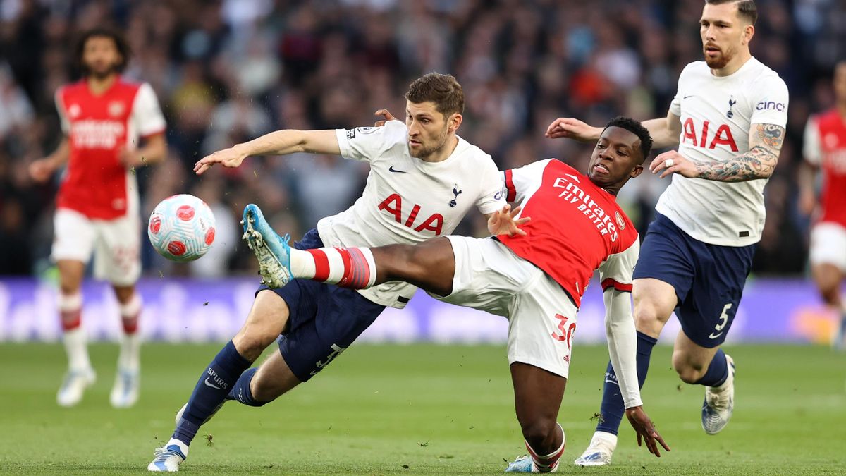 Eddie Nketiah of Arsenal tackles Ben Davies of Tottenham Hotspur during the Premier League match between Tottenham Hotspur and Arsenal at Tottenham Hotspur Stadium on May 12, 2022 in London, United Kingdom. (Photo by James Williamson - AMA/Getty Images)