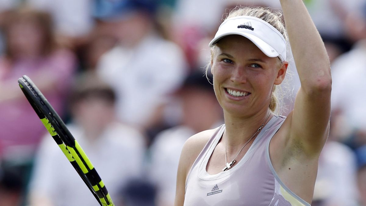 Denmark's Caroline Wozniacki celebrates victory in the first round.