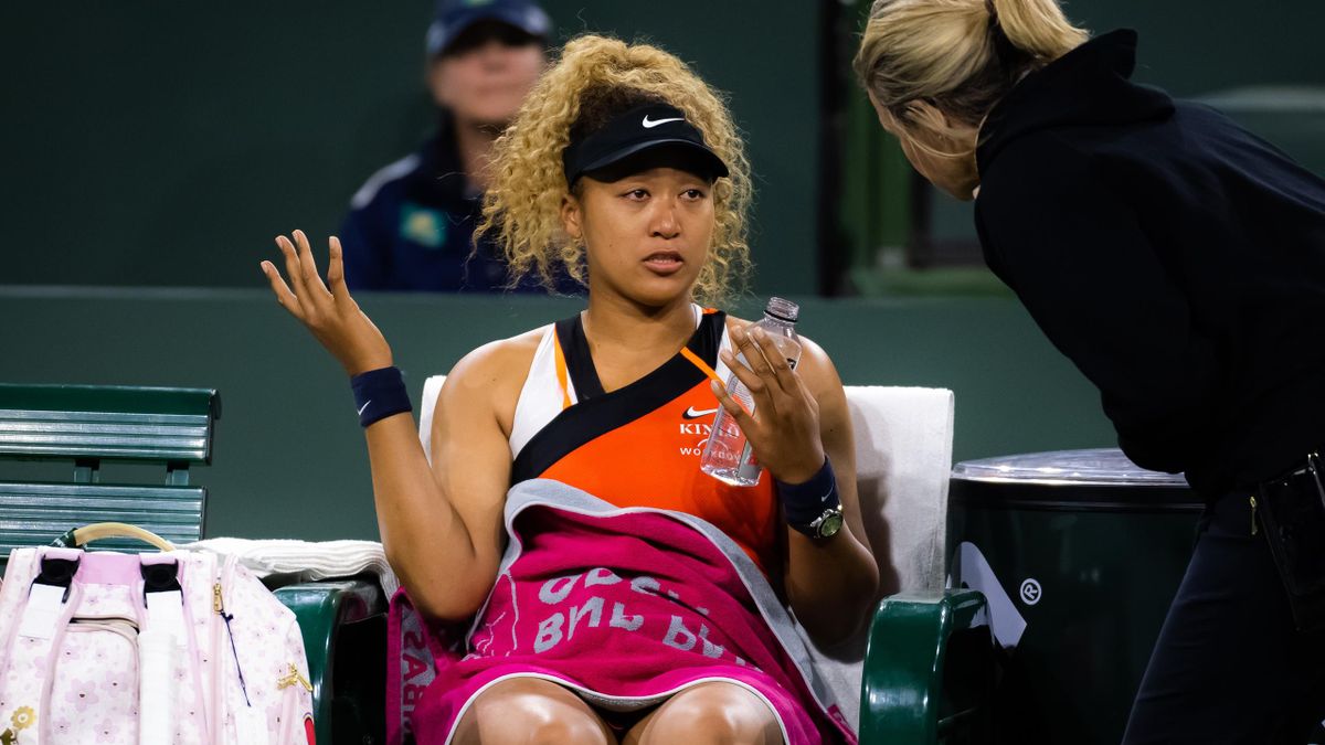 Naomi Osaka of Japan talks to referee Clare Wood after being heckled by a fan in her second-round match against Veronika Kudermetova of Russia at the 2022 BNP Paribas Open