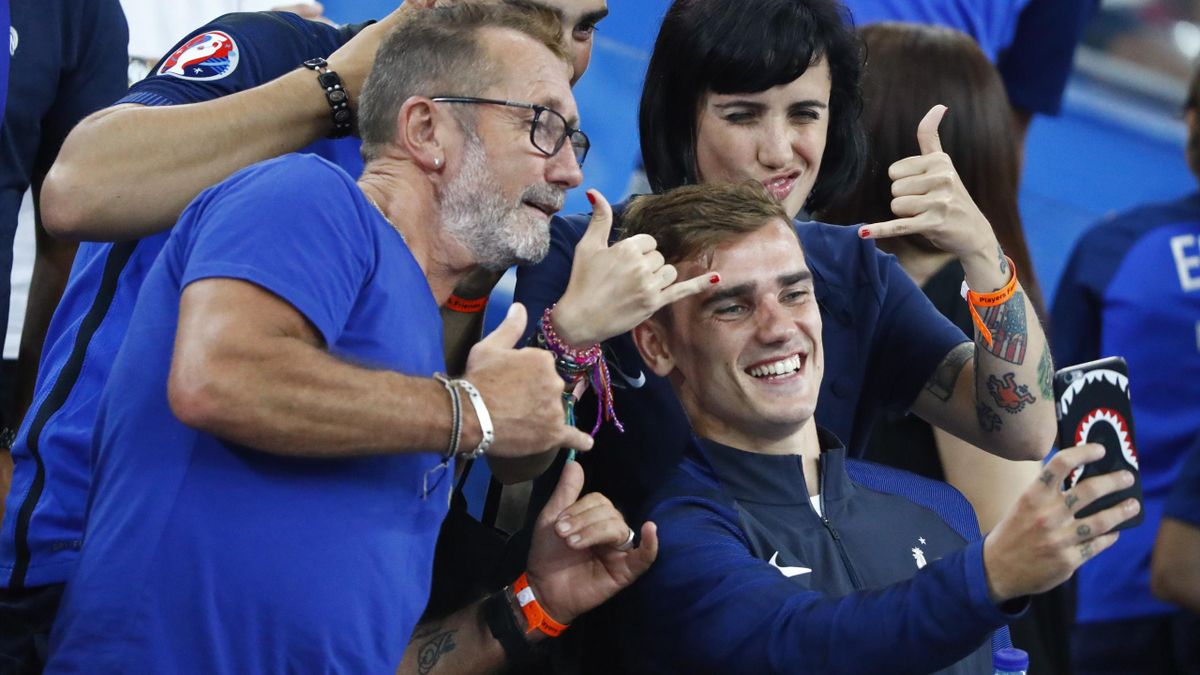 France's Antoine Griezmann poses for a picture after the match