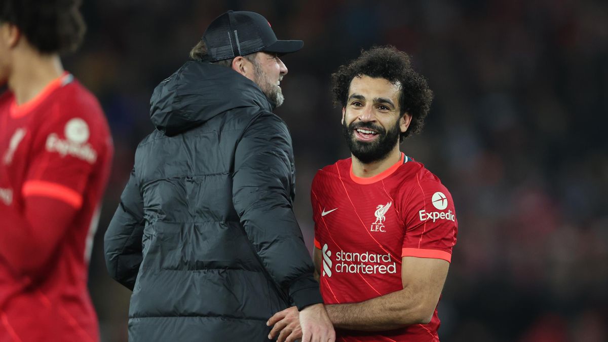 Mohamed Salah embraces Juergen Klopp, Manager of Liverpool after their sides victory in the Premier League match between Liverpool and Arsenal at Anfield on November 20, 2021 in Liverpool, England.