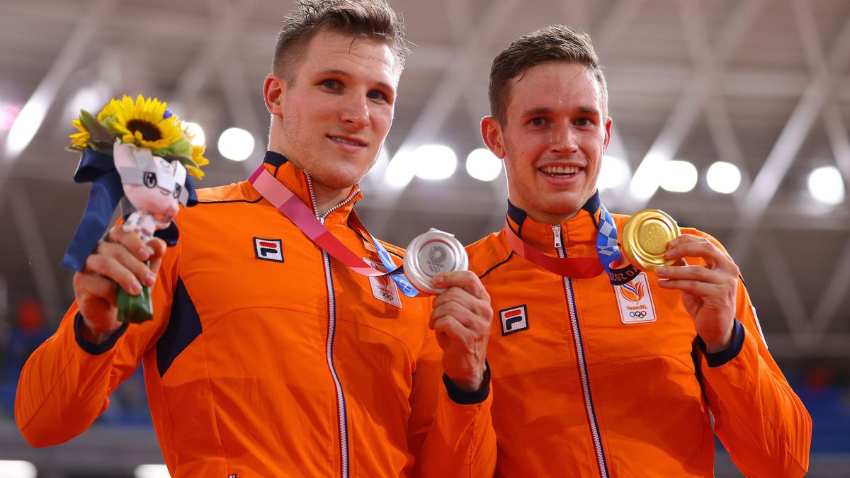 Silver medalist Jeffrey Hoogland and gold medalist Harrie Lavreysen of Team Netherlands pose on the podium during the medal ceremony after the Men's sprint finals of the track cycling on day fourteen of the Tokyo 2020 Olympic Games at Izu Velodrome on Aug