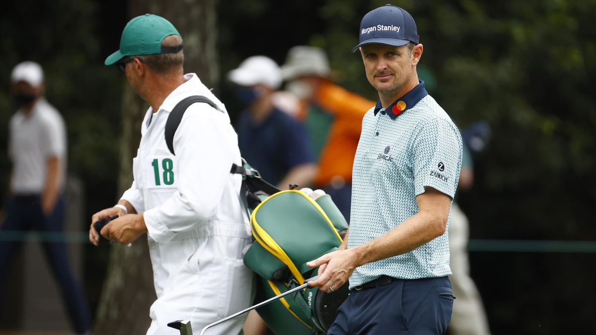 Justin Rose of England walks up the first fairway with his caddie David Clark during the second round of the Masters at Augusta National Golf Club on 9 April, 2021 in Augusta, Georgia
