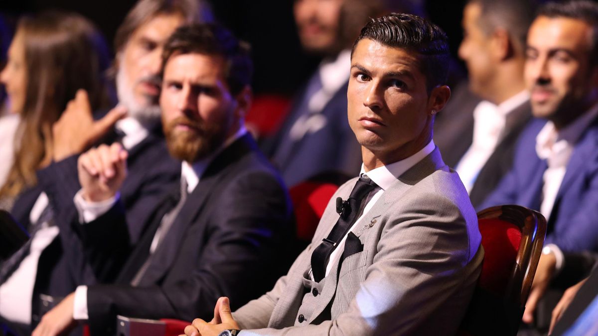 Real Madrid's Portuguese forward Cristiano Ronaldo (R) sits alongside Barcelona's Argentinian forward Lionel Messi (L)