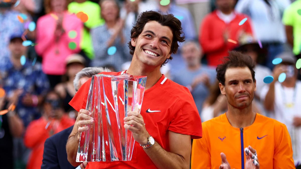 Taylor Fritz of the United States holds his winners trophy after his straight sets victory against Rafael Nadal of Spain in the men's Final on Day 14 of the BNP Paribas Open at the Indian Wells Tennis Garden