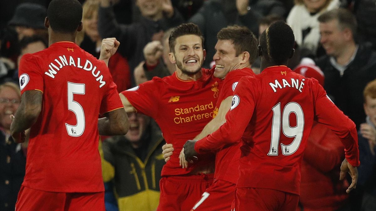 Liverpool's Adam Lallana celebrates scoring their first goal with James Milner and Sadio Mane