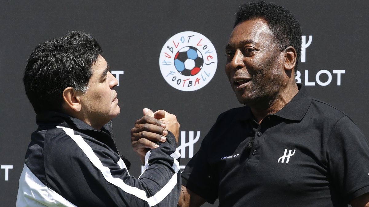 Former Argentinian football international Diego Maradona (L) and former Brazilian footballer Pele pose after a football match organised by Swiss luxury watchmaker Hublot at the Jardin du Palais Royal in Paris on June 9, 2016, on the eve of the Euro 2016 E