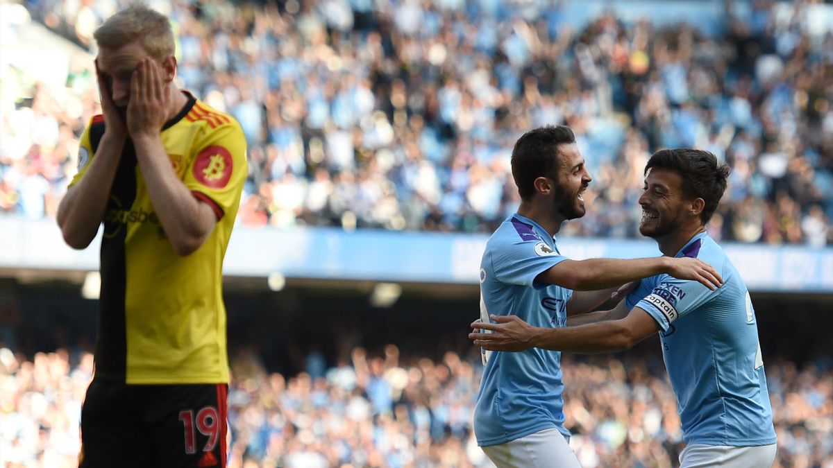 Manchester City's Portuguese midfielder Bernardo Silva (C) celebrates with Manchester City's Spanish midfielder David Silva (R) after he scores the team's seventh goal during the English Premier League football match between Manchester City and Watford at