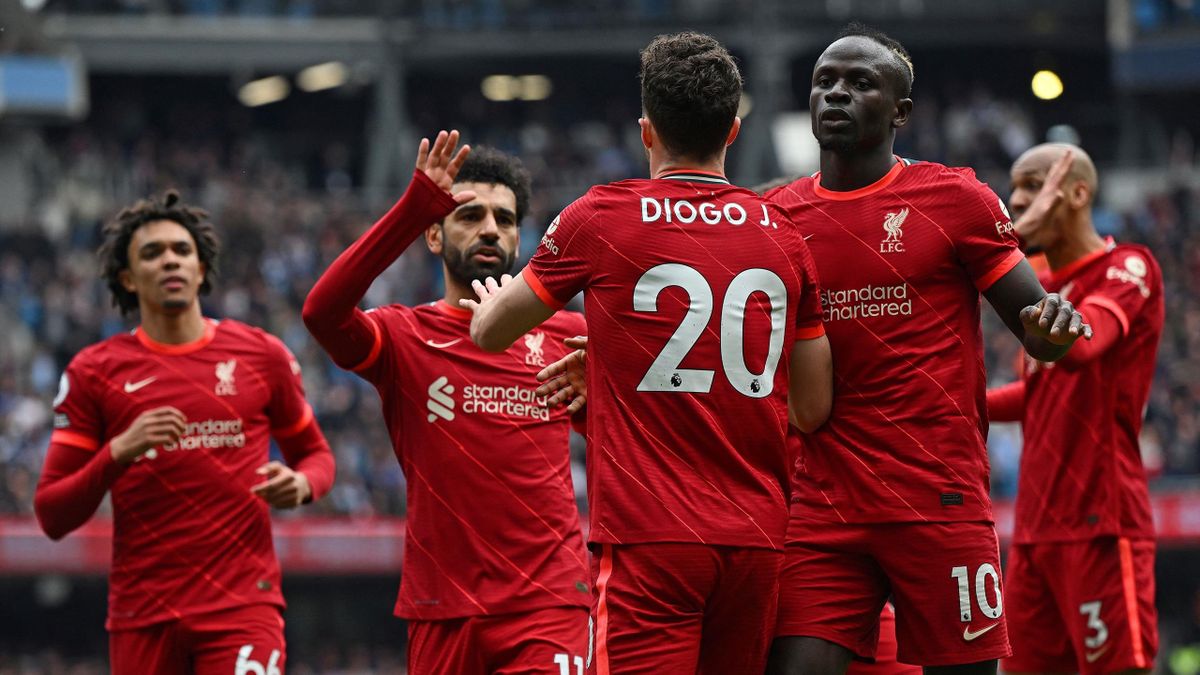 Liverpool's Portuguese striker Diogo Jota celebrates after scoring the equalising goal with Liverpool's Egyptian midfielder Mohamed Salah and Liverpool's Senegalese striker Sadio Mane during the English Premier League football match between Manchester Cit