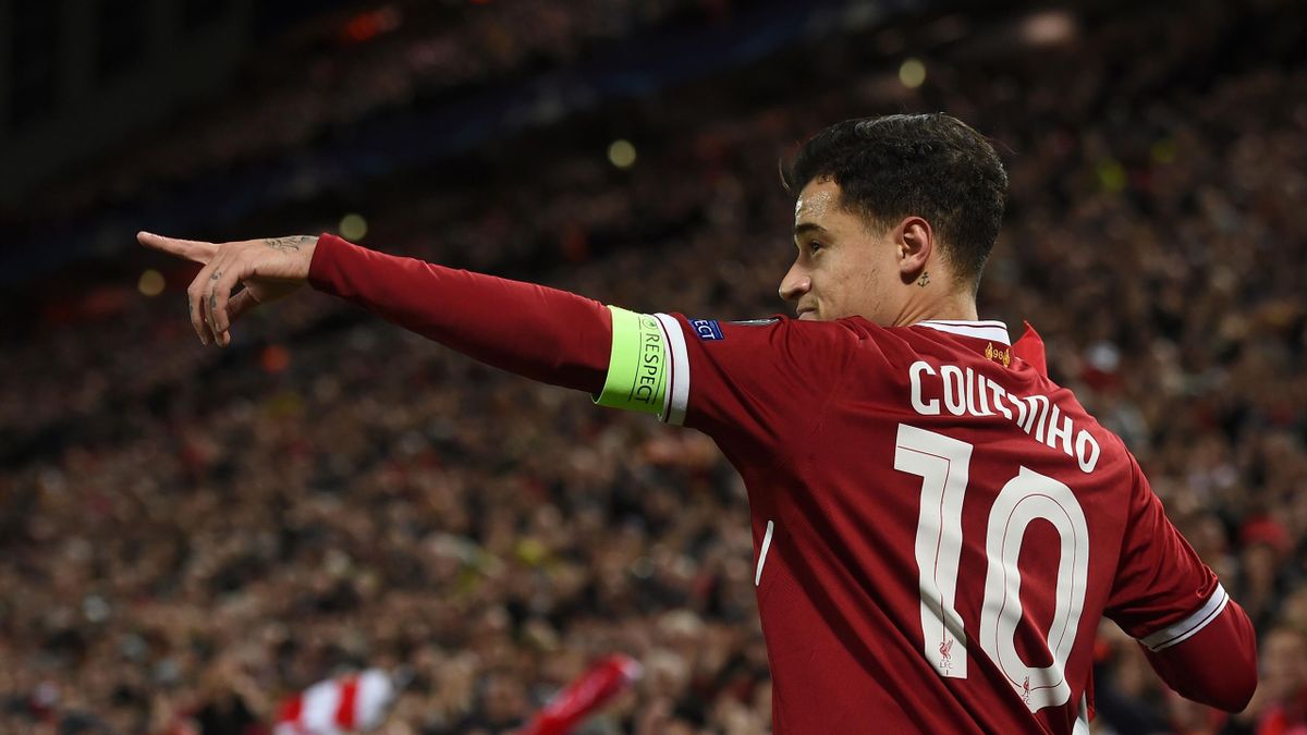 Liverpool's Brazilian midfielder Philippe Coutinho points to his team-mates after scoring their second goal during the UEFA Champions League Group E football match between Liverpool and Spartak Moscow at Anfield in Liverpool, north-west England on Decembe