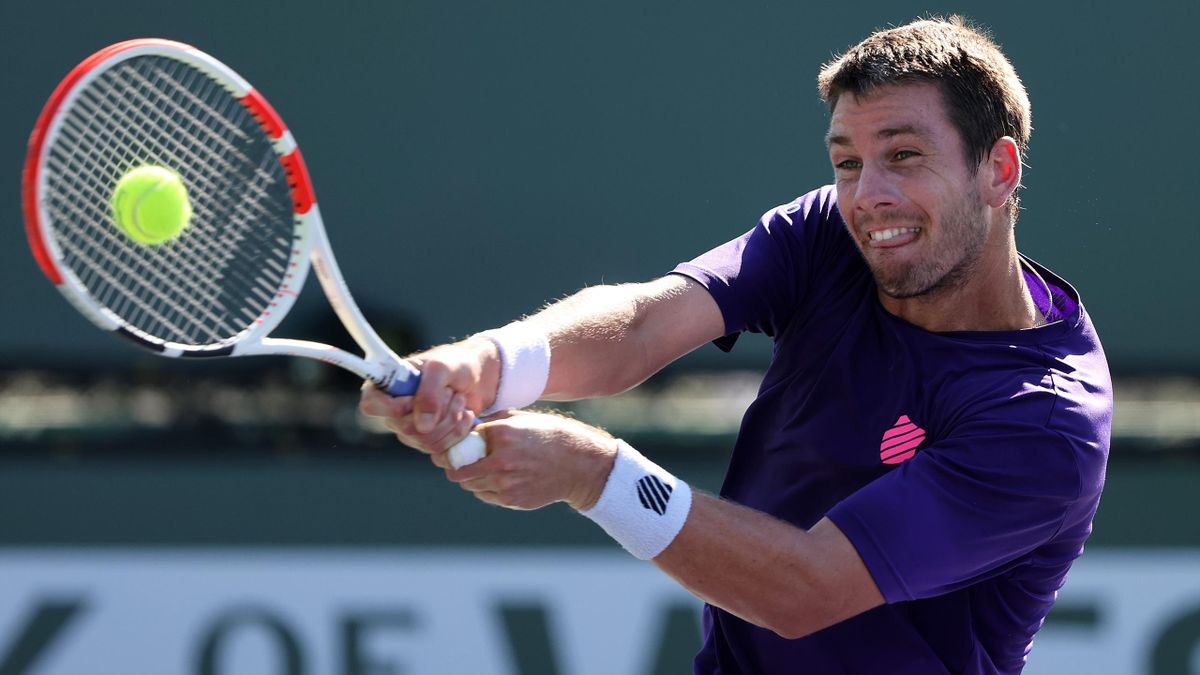 Cameron Norrie of Great Britain plays a backhand against Tennys Sandgren of the United States during their second round match on Day 6 of the BNP Paribas Open