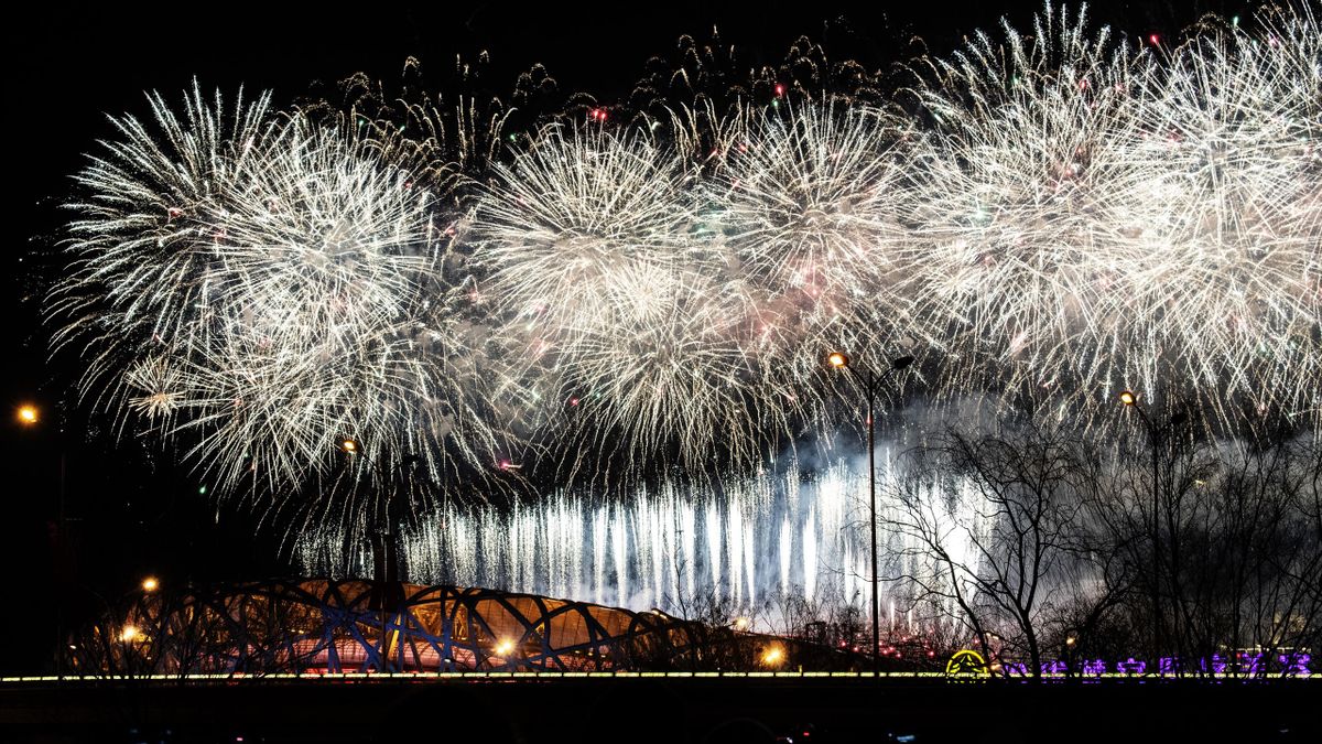 Fireworks explode over the Beijing National Stadium, also known as the Birds Nest, and the skyline of the city during the closing ceremony of the Beijing 2022 Winter Olympics on February 20, 2022