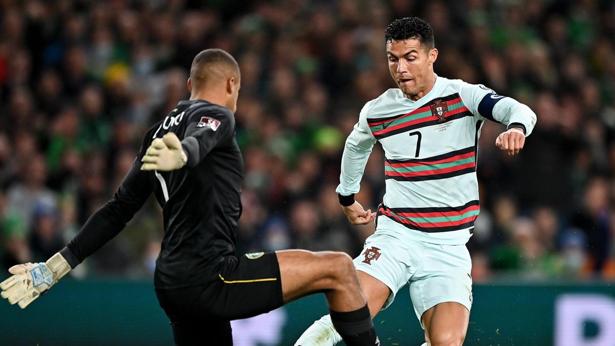 Cristiano Ronaldo of Portugal is tackled by Republic of Ireland goalkeeper Gavin Bazunu