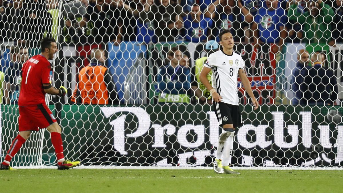 Germany's Mesut Ozil reacts after missing as Italy's Gianluigi Buffon celebrates during the penalty shootout