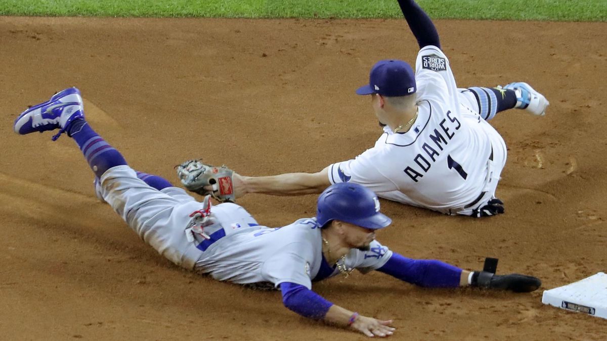 Mookie Betts (L) of the Los Angeles Dodgers steals second base in the sixth inning in Game 3 of the World Series against the Tampa Bay Rays