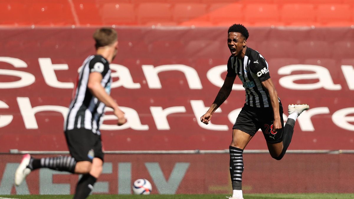 Joe Willock of Newcastle United celebrates after scoring their side's first goal during the Premier League match between Liverpool and Newcastle United at Anfield